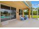 Covered patio with outdoor seating, offering views of the pool and landscaped backyard at 370 Londonderry Dr, Sarasota, FL 34240