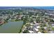 Panoramic aerial shot of the property nestled by a lake, highlighting its location in a residential area at 415 Courbet Dr # 415, Nokomis, FL 34275