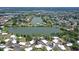 Wide aerial view showcasing the property's lakeside location and the surrounding neighborhood at 415 Courbet Dr # 415, Nokomis, FL 34275