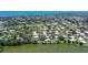 An aerial view of waterfront homes with a lake, bay, and beautiful landscaping at 415 Courbet Dr # 415, Nokomis, FL 34275