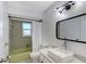 Vintage bathroom features a green tub and tile, along with a modern sink, mirror and contemporary lighting at 415 Courbet Dr # 415, Nokomis, FL 34275