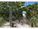 Picturesque beach path lined with lush greenery and leading to pristine sandy shores at 415 Courbet Dr # 415, Nokomis, FL 34275