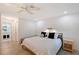 Bright bedroom boasts a ceiling fan, recessed lighting, a view to the bathroom, and a wood bed frame at 415 Courbet Dr # 415, Nokomis, FL 34275