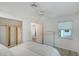 Bright bedroom with a ceiling fan, closet, and an adjacent doorway leading to another room at 415 Courbet Dr # 415, Nokomis, FL 34275
