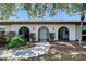 Attractive front exterior showcasing arched entryways, meticulous landscaping, and a pristine walkway at 415 Courbet Dr # 415, Nokomis, FL 34275