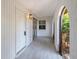 Inviting front porch featuring a tiled floor and views to landscaped front yard at 415 Courbet Dr # 415, Nokomis, FL 34275