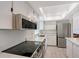 Bright kitchen features stainless steel appliances, white cabinets, stone countertops, and recessed lighting at 415 Courbet Dr # 415, Nokomis, FL 34275