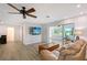 Open floor plan living room with sliding glass doors to enclosed porch at 415 Courbet Dr # 415, Nokomis, FL 34275
