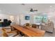 Open floor plan living room featuring an oversized wood table for dining at 415 Courbet Dr # 415, Nokomis, FL 34275