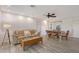 Open floor plan living room with wood-look flooring and neutral decor at 415 Courbet Dr # 415, Nokomis, FL 34275