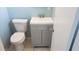 Charming bathroom featuring a modern gray vanity, white sink, and a matching toilet for a clean, updated look at 4304 78Th W St # 4304, Bradenton, FL 34209