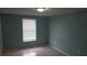 Inviting bedroom with blue walls, neutral tile flooring, and a bright window for natural light at 4304 78Th W St # 4304, Bradenton, FL 34209