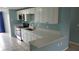 Modern kitchen featuring stainless steel appliances, white cabinets, and stone countertops at 4304 78Th W St # 4304, Bradenton, FL 34209