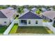 Aerial view of backyard featuring white fence, green grass, and a covered patio at 4315 Deep Creek Ter, Parrish, FL 34219