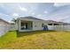 Well-maintained backyard featuring lush lawn, white picket fence, and a covered patio at 4315 Deep Creek Ter, Parrish, FL 34219