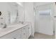 Modern bathroom featuring dual sinks, ample counter space, and a shower with glass doors at 4315 Deep Creek Ter, Parrish, FL 34219