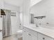 Well-lit bathroom featuring white vanity, decorative mirror, and a shower-tub combination at 4315 Deep Creek Ter, Parrish, FL 34219
