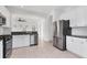 Modern kitchen with stainless appliances and a view to an open concept living area at 4315 Deep Creek Ter, Parrish, FL 34219