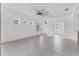 Spacious living room featuring tiled floors, ceiling fan, and abundant natural light at 4315 Deep Creek Ter, Parrish, FL 34219