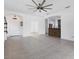Bright open-concept living room featuring tile flooring and a view into the modern kitchen at 4315 Deep Creek Ter, Parrish, FL 34219