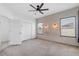 Bright bedroom features a carpeted floor, a ceiling fan, and decorative wall paneling at 4315 Deep Creek Ter, Parrish, FL 34219