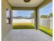 Covered patio area offering backyard view with a white picket fence and green lawn at 4315 Deep Creek Ter, Parrish, FL 34219