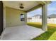 Covered patio with fan, view of backyard, and white picket fence surrounding green grass at 4315 Deep Creek Ter, Parrish, FL 34219
