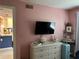 Bedroom with a TV, dresser, and view into the kitchen creates a relaxed and connected living space at 433 Cerromar Ln # 331, Venice, FL 34293