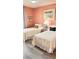 Bright bedroom featuring two twin beds with light gray flooring and decor at 433 Cerromar Ln # 331, Venice, FL 34293