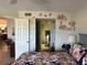 Bedroom with floral decoration, view of a bathroom, and an adjacent kitchen at 433 Cerromar Ln # 331, Venice, FL 34293