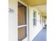 Hallway leading to unit door featuring well-lit corridor and unit number at 433 Cerromar Ln # 331, Venice, FL 34293