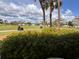 Scenic golf course view with golf carts on the path and lush greenery under a cloudy sky at 433 Cerromar Ln # 331, Venice, FL 34293
