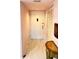 Entry hallway with beautiful tile floors and detailed console table at 433 Cerromar Ln # 331, Venice, FL 34293