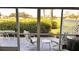 Screened-in lanai with seating and a view of the golf course at 433 Cerromar Ln # 331, Venice, FL 34293