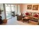 Living room with a sofa, armchair, and sliding glass doors to the lanai at 433 Cerromar Ln # 331, Venice, FL 34293