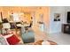 Cozy living room with a sofa, armchair, and a view of the dining area and kitchen at 433 Cerromar Ln # 331, Venice, FL 34293