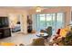 Bright living room featuring neutral tile floors, ceiling fan, and sliding glass doors to lanai at 433 Cerromar Ln # 331, Venice, FL 34293