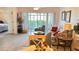 Cozy living room featuring neutral tile floors, ceiling fan, and large sliding glass doors to lanai at 433 Cerromar Ln # 331, Venice, FL 34293