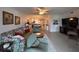 Open-concept floor plan featuring neutral tile floors and living room with view to kitchen at 433 Cerromar Ln # 331, Venice, FL 34293