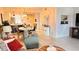 Cozy living room with a sofa, armchair, and a view of the dining area and kitchen at 433 Cerromar Ln # 331, Venice, FL 34293