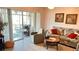 Living room with a sofa, armchair, and sliding glass doors to the lanai at 433 Cerromar Ln # 331, Venice, FL 34293