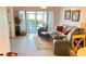 Inviting living room featuring neutral tile floors and large sliding glass doors to the lanai at 433 Cerromar Ln # 331, Venice, FL 34293