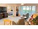 Living room with television, lanai access, and view to bedroom at 433 Cerromar Ln # 331, Venice, FL 34293