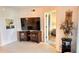 Living room with a television, cabinet, and view of the lanai at 433 Cerromar Ln # 331, Venice, FL 34293