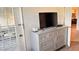 Light filled main bedroom with dresser and view to attached bathroom and kitchen at 433 Cerromar Ln # 331, Venice, FL 34293