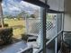 Screened-in patio with seating area overlooking lush greenery and golf course at 433 Cerromar Ln # 331, Venice, FL 34293