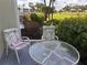 Cozy patio area with comfortable chairs and a table, overlooking landscaped gardens and the golf course at 433 Cerromar Ln # 331, Venice, FL 34293