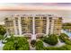 Aerial view of luxurious condos with beach access, beautifully landscaped grounds, and inviting pool area at 435 L Ambiance Dr # K506, Longboat Key, FL 34228
