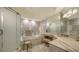 Luxurious marble bathroom with a soaking tub, glass shower, and vanity area at 435 L Ambiance Dr # K506, Longboat Key, FL 34228