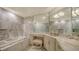 Luxurious marble bathroom with a soaking tub, glass shower, and vanity area at 435 L Ambiance Dr # K506, Longboat Key, FL 34228